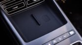 Close-up of a car's center console with two air vents and a textured storage pad beneath them