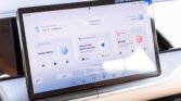 Car infotainment tablet showing music apps (KuGou Music, Ximalaya) and weather widgets on a car dashboard