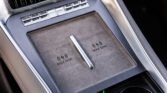 Center console in a car showing a wireless charging pad labeled 'MAX 50W' and surrounding controls below an air vent.