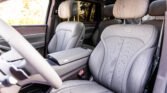 Front seats in a luxury car with perforated gray leather and adjustable headrests
