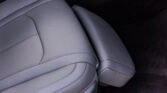 Grey perforated car seat upholstery with stitching detail in a vehicle interior