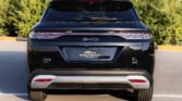 Rear view of a black BYD SUV parked in a lot, showing distinctive taillights and rear window wiper.