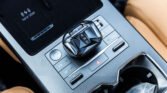 Close-up of a polygonal gear selector showing P, R, N, D on the center console of a car
