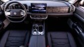 Luxurious car interior with leather seats, steering wheel, and a large central touchscreen display