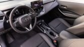 Interior of a modern car cabin with steering wheel, digital dashboard, and center touchscreen display. (Front seats and console visible)