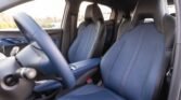 Blue fabric front car seats with sporty bucket design, view from driver’s side of a modern car interior